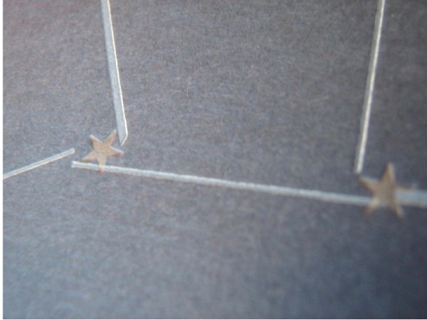 Slide05.jpg Photograph of paper stars connected with popsicle sticks