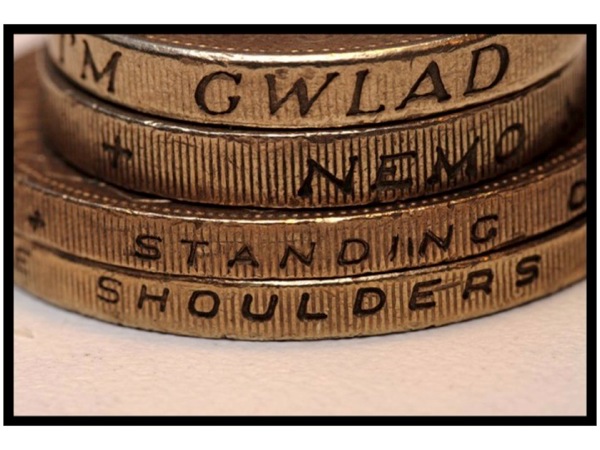 Slide73.jpg Photo of the edge of coins, with the words *Standing On* and *Shoulders* visible